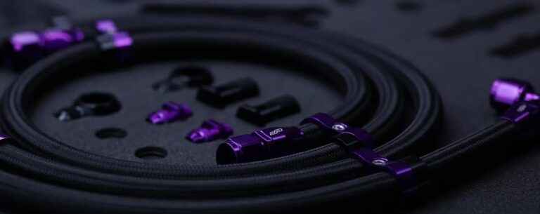 Purple AN Fittings assembled to a black braided nylon hose with several metric adapters.